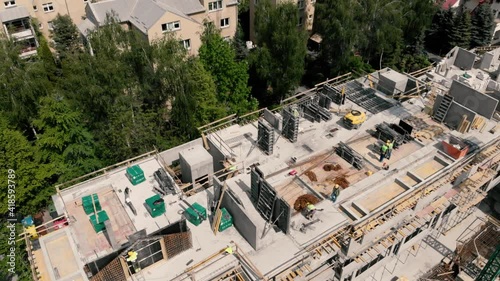 drone footage top down, builders work at a construction site