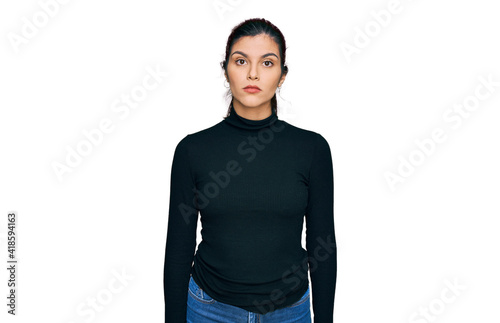 Young hispanic woman wearing casual clothes relaxed with serious expression on face. simple and natural looking at the camera.