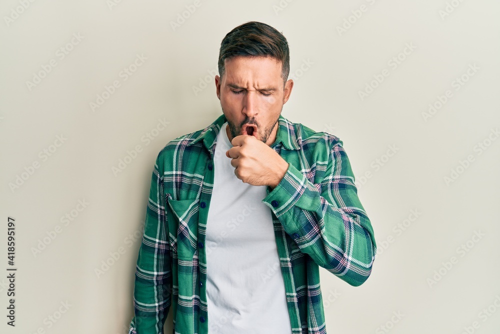 Fototapeta premium Handsome man with beard wearing casual clothes feeling unwell and coughing as symptom for cold or bronchitis. health care concept.