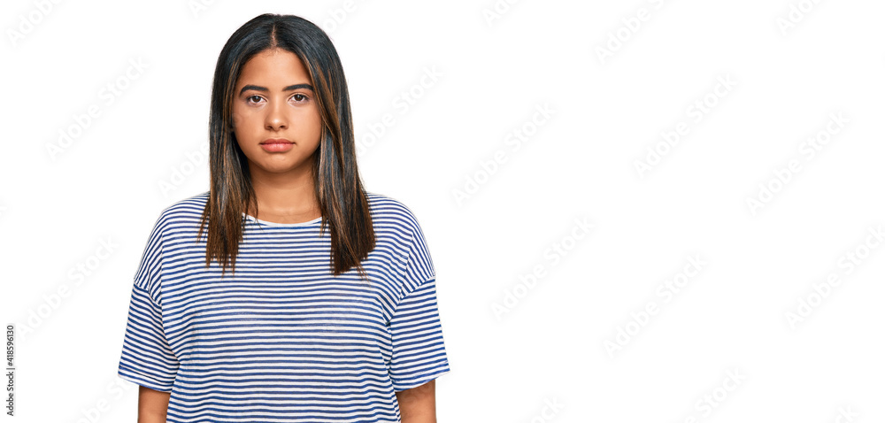 Young latin girl wearing casual clothes relaxed with serious expression on face. simple and natural looking at the camera.