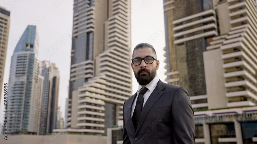 Serious Young Man In Business Suit On Background Of The City. Tall Buildings Dubai. Confident Businessman. Serious Young Man In Business Suit On Background Of The City. Tall Buildings Dubai. Confident Businessman.