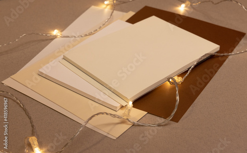 empty blank, sheets and notebooks  with lights on grey background 