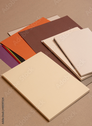 stack of books and sheets  on gray background 
