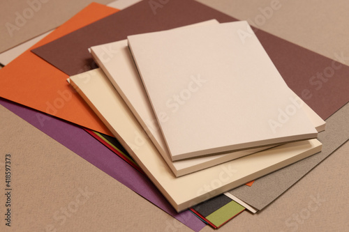stack of books and sheets  on gray background 
