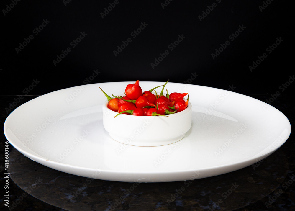 Biquinho pepper isolated oh the white plate Biquinho pepper isolated oh the white plate