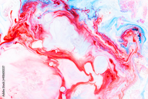 Fluid art. Abstract colorful background, wallpaper. Liquid marbling background. Mixed blue and light pink paints. Trendy colorful backdrop