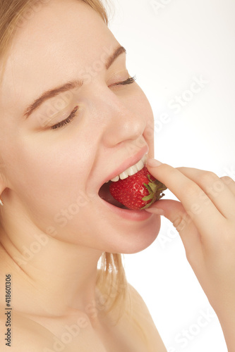 girl eats strawberry