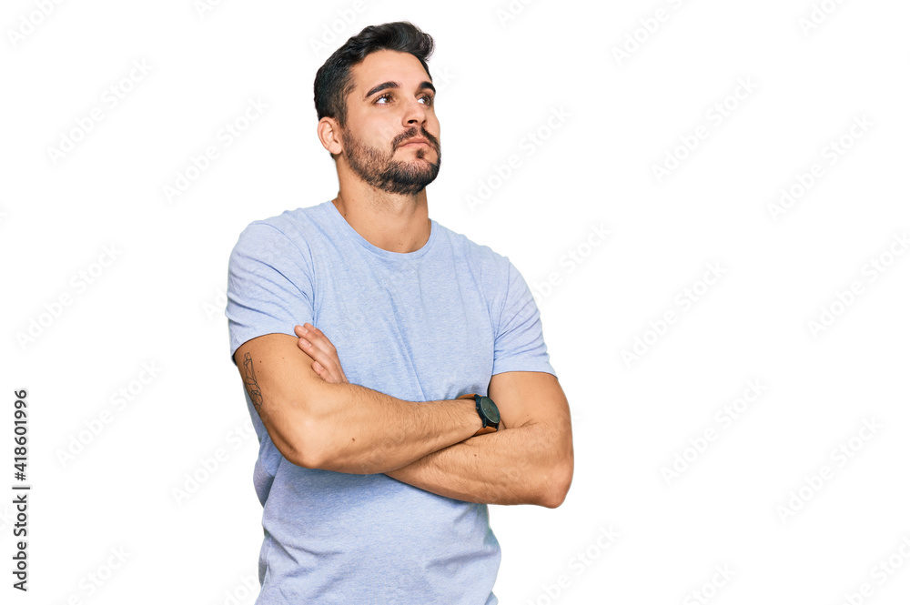 Young hispanic man wearing casual clothes looking to the side with arms crossed convinced and confident Young hispanic man wearing casual clothes looking to the side with arms crossed convinced and confident