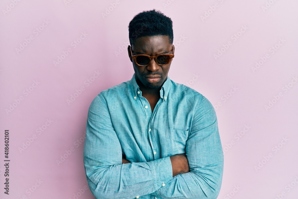Handsome business black man wearing stylish sunglasses skeptic and nervous, disapproving expression on face with crossed arms. negative person. Handsome business black man wearing stylish sunglasses skeptic and nervous, disapproving expression on face with crossed arms. negative person.