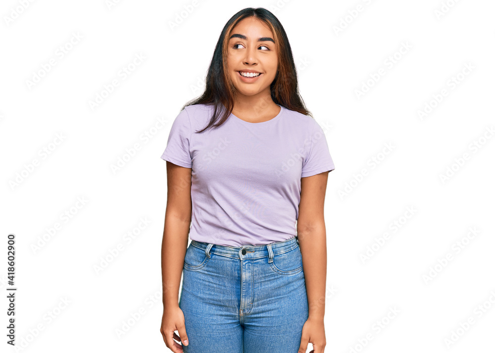 Young latin woman wearing casual clothes smiling looking to the side and staring away thinking. Young latin woman wearing casual clothes smiling looking to the side and staring away thinking.