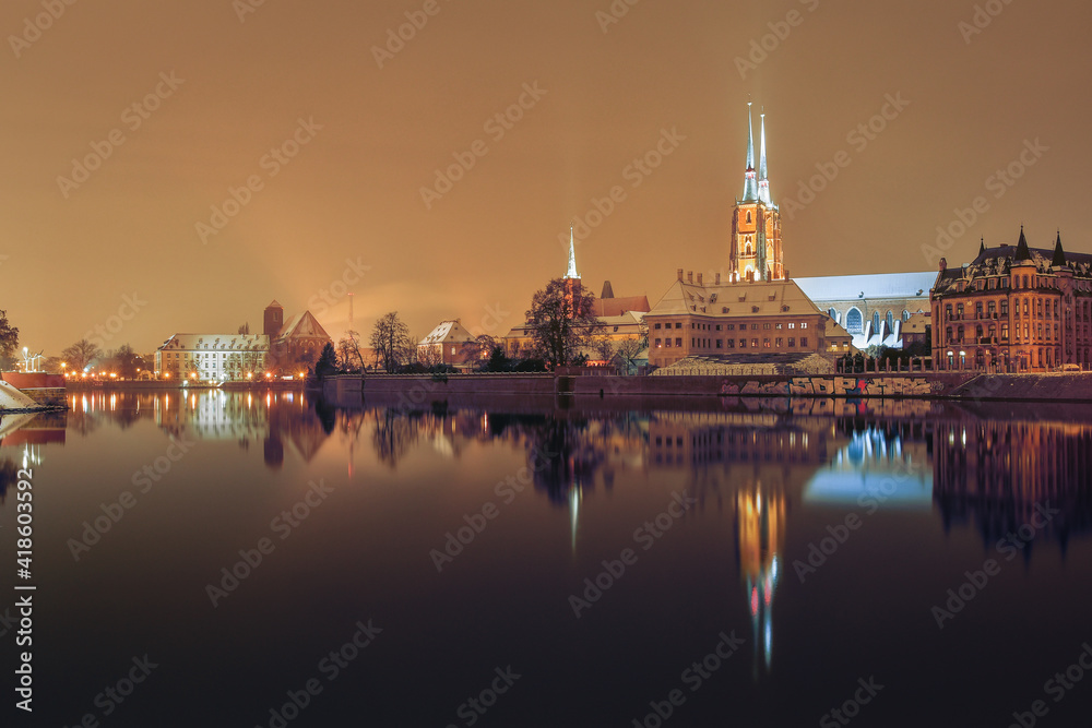 Cathedral of St. John the Baptist in Wroclaw on the Odra River, illuminated at night.