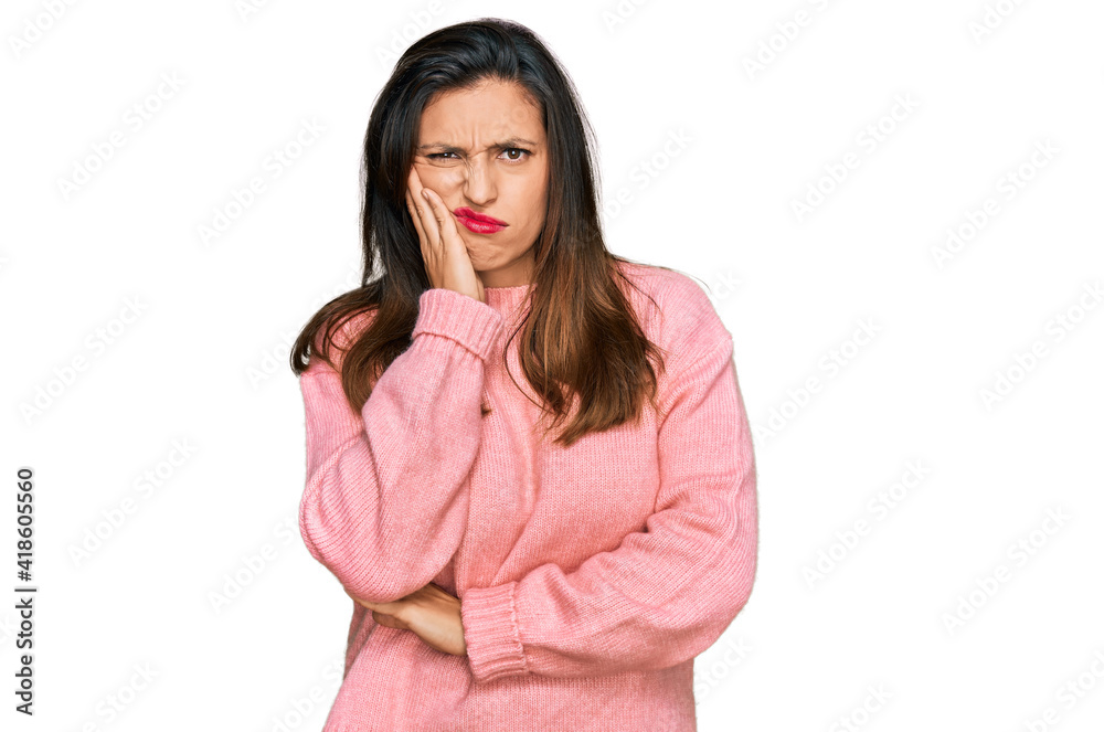 Beautiful hispanic woman wearing casual winter sweater thinking looking tired and bored with depression problems with crossed arms. Beautiful hispanic woman wearing casual winter sweater thinking looking tired and bored with depression problems with crossed arms.