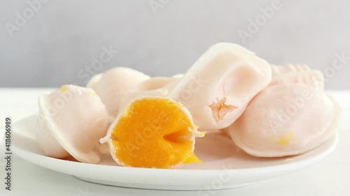 Hand taking a traditional portuguese sweet called Ovos Moles de Aveiro