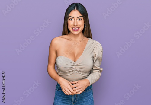 Young hispanic woman wearing casual clothes with a happy and cool smile on face. lucky person.