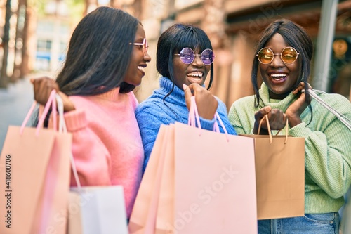 Three african american friends going shopping at the city.