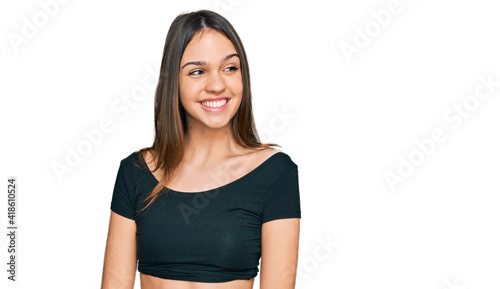 Young brunette woman wearing casual clothes looking away to side with smile on face, natural expression. laughing confident. © Krakenimages.com