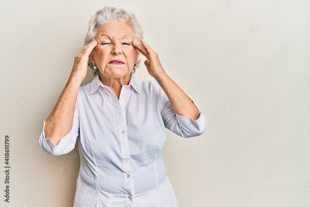 Senior grey-haired woman wearing casual clothes with hand on head, headache because stress. suffering migraine. Senior grey-haired woman wearing casual clothes with hand on head, headache because stress. suffering migraine.