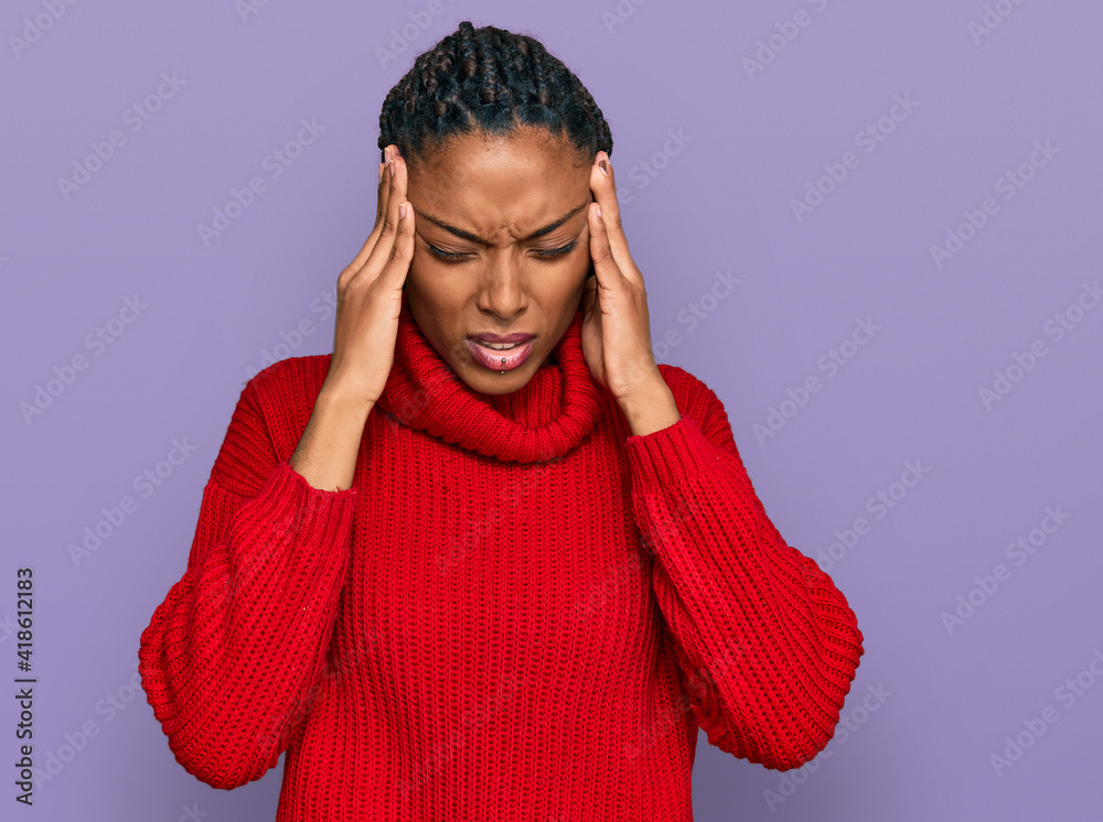 African american woman wearing casual winter sweater with hand on head for pain in head because stress. suffering migraine. African american woman wearing casual winter sweater with hand on head for pain in head because stress. suffering migraine.