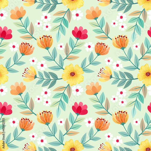 Colorful hand drawn flowers seamless pattern design on light green background for fabric, textile, and wallpaper.