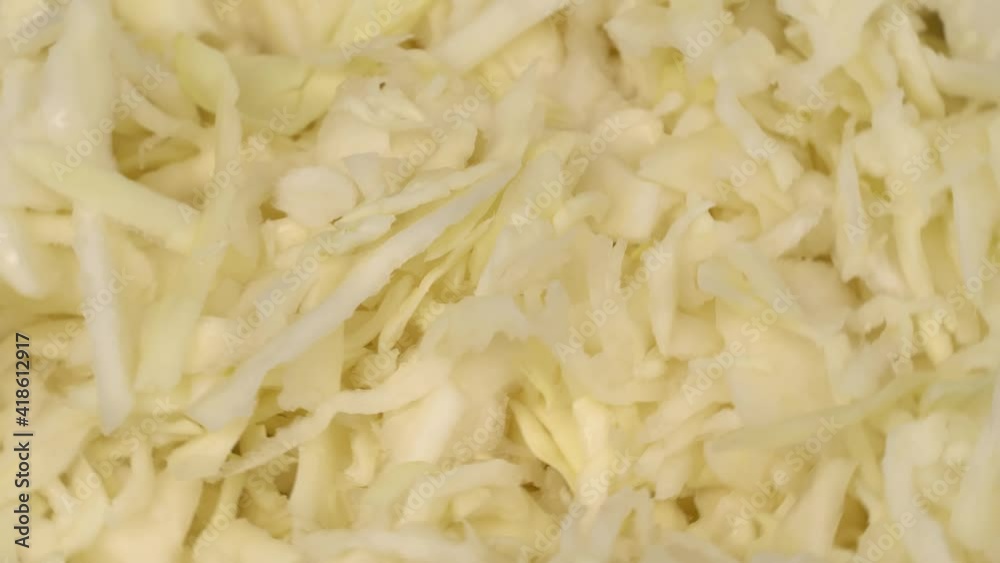 finely chopped white cabbage close-up rotates on the turntable around its axis. finely chopped white cabbage close-up rotates on the turntable around its axis.