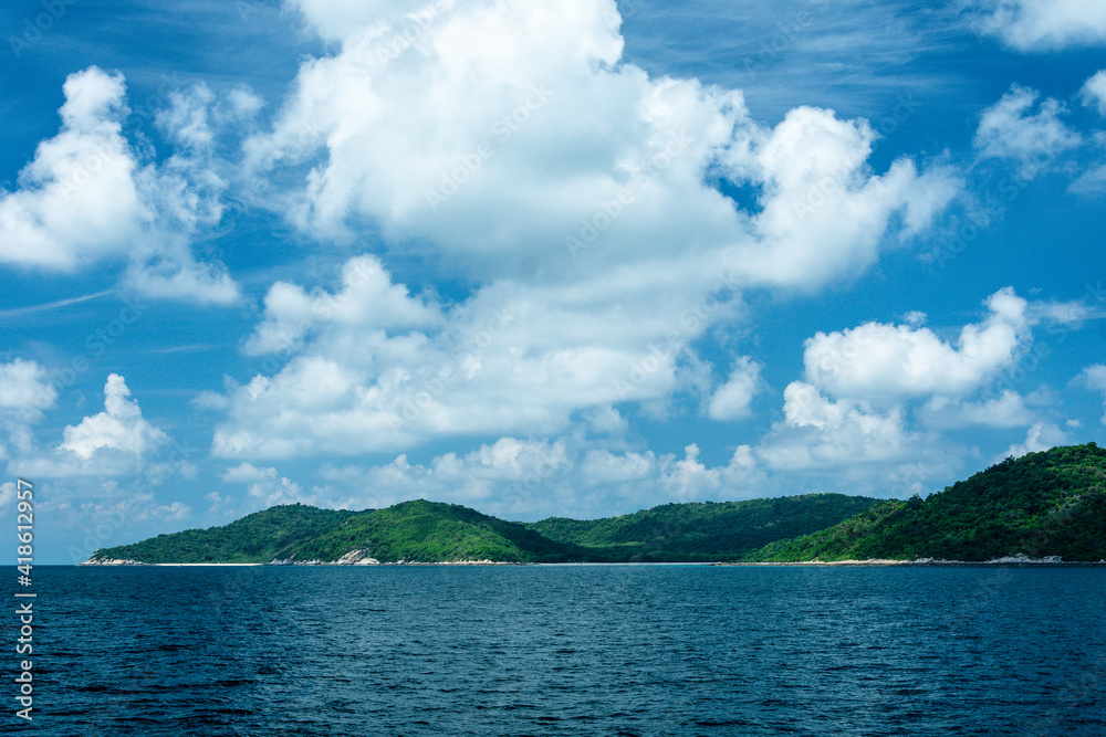 Tropical islands island in the Gulf of Thailand with montains, blue sky, clouds.