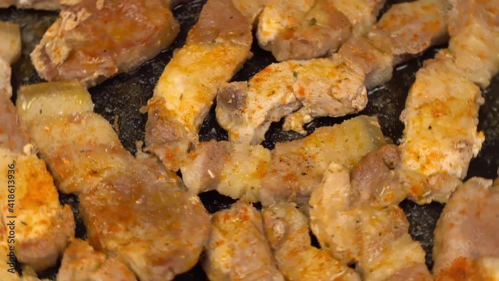 Close-up of slices of roast pork or beef in a frying pan. Spin and turn dolly. Close-up of slices of roast pork or beef in a frying pan. Spin and turn dolly.