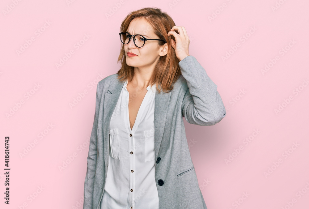Young caucasian woman wearing business style and glasses confuse and wondering about question. uncertain with doubt, thinking with hand on head. pensive concept.