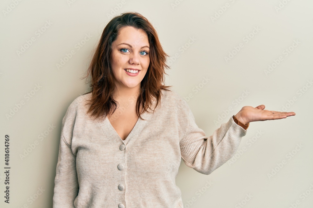 Young caucasian woman wearing casual clothes smiling cheerful presenting and pointing with palm of hand looking at the camera. Young caucasian woman wearing casual clothes smiling cheerful presenting and pointing with palm of hand looking at the camera.