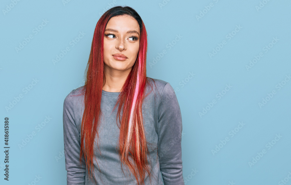 Young caucasian woman wearing casual clothes smiling looking to the side and staring away thinking. Young caucasian woman wearing casual clothes smiling looking to the side and staring away thinking.