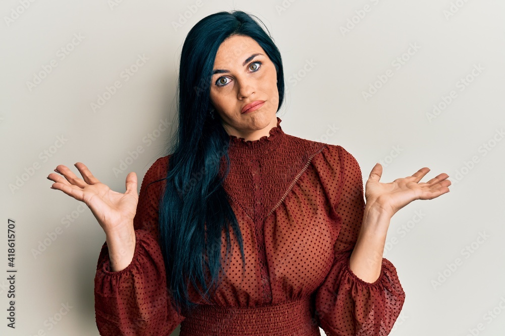 Young caucasian woman wearing casual clothes clueless and confused with open arms, no idea and doubtful face. Young caucasian woman wearing casual clothes clueless and confused with open arms, no idea and doubtful face.