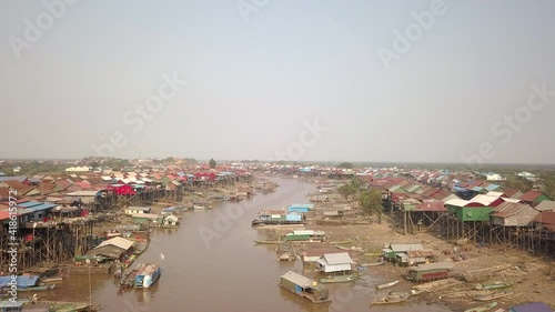 fly over a floating village of stilted houses along the tonle sap river