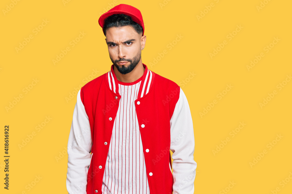 Young man with beard wearing baseball uniform skeptic and nervous, frowning upset because of problem. negative person. Young man with beard wearing baseball uniform skeptic and nervous, frowning upset because of problem. negative person.