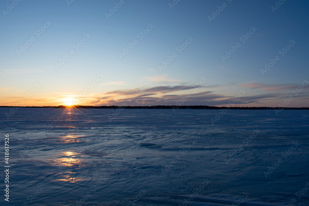 sunset over the frozen lake