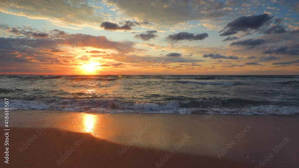 Tropical beach sunrise. Ocean waves splashing on the sand, 4k video Tropical beach sunrise. Ocean waves splashing on the sand, 4k video
