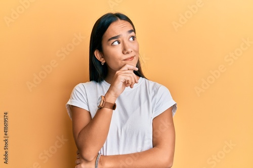 Obraz na plátně Young asian woman wearing casual white t shirt thinking concentrated about doubt