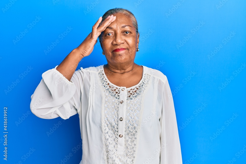 Senior african american woman wearing casual clothes surprised with hand on head for mistake, remember error. forgot, bad memory concept. Senior african american woman wearing casual clothes surprised with hand on head for mistake, remember error. forgot, bad memory concept.