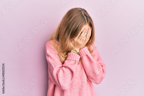 Beautiful young caucasian girl wearing casual clothes with sad expression covering face with hands while crying. depression concept. © Krakenimages.com
