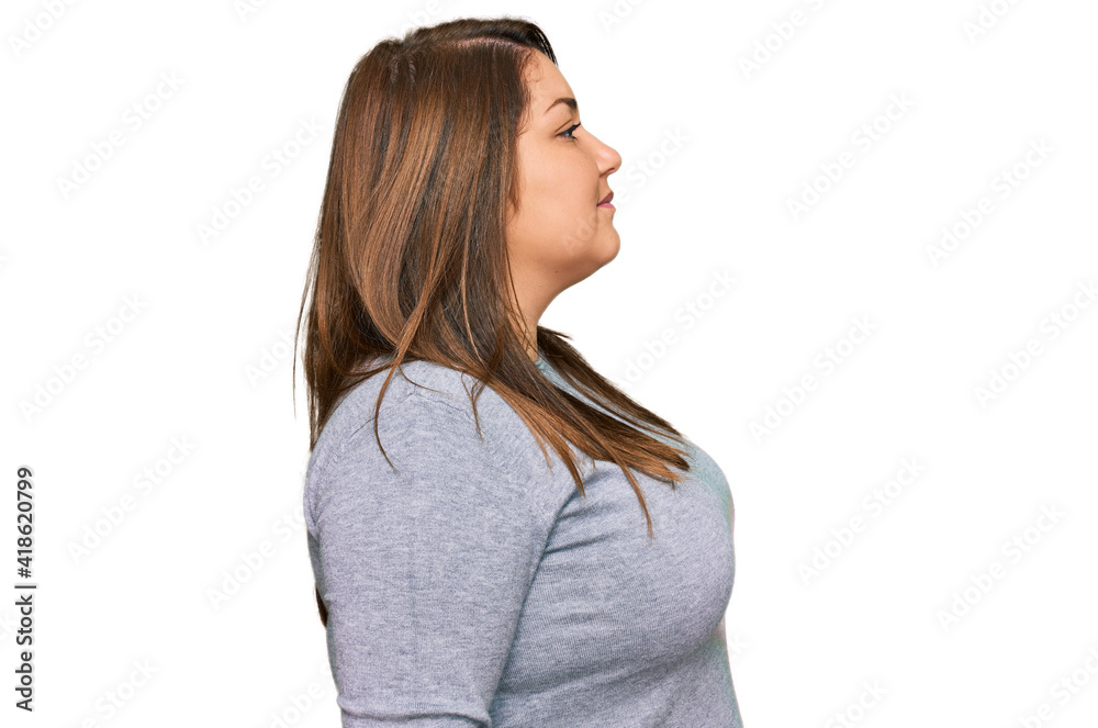 Beautiful brunette plus size woman wearing casual clothes looking to side, relax profile pose with natural face and confident smile. Beautiful brunette plus size woman wearing casual clothes looking to side, relax profile pose with natural face and confident smile.
