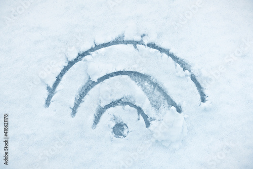 Wi-fi symbol written in the snow. Abstract concept of wireless communication.