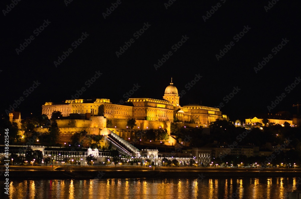 The famous Buda castle illuminated at night shot across river Danube in Budapest, Hungary