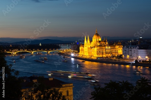 Night view of illuminated beautiful Parliament building across river Danube in Budapest, Hungary