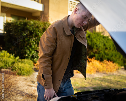 man under car hood © Ian