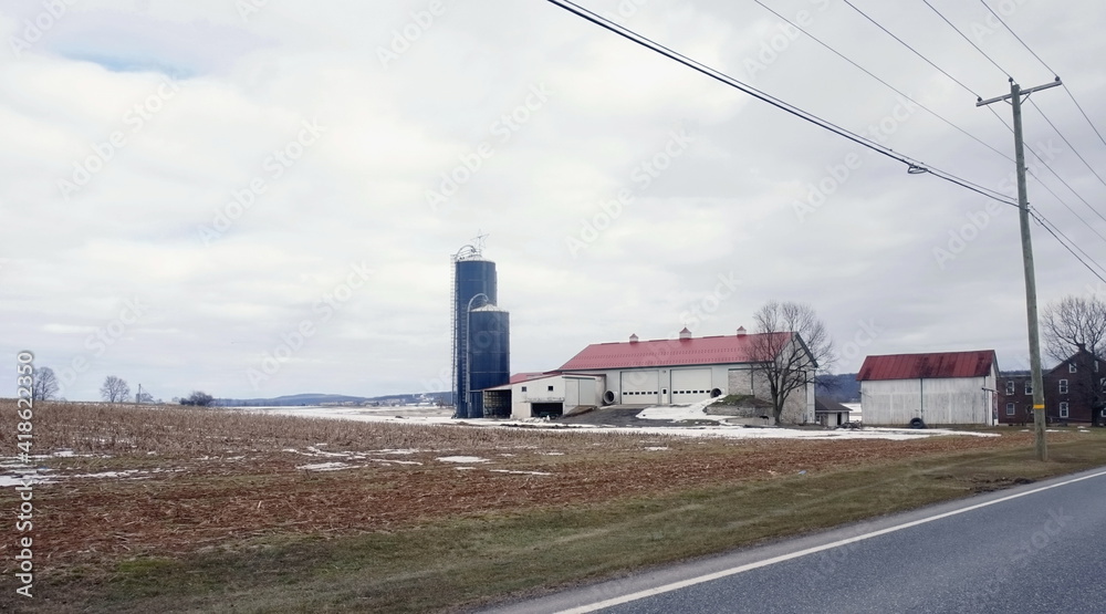 White Farm Buildings with Blue Silo in Winter White Farm Buildings with Blue Silo in Winter