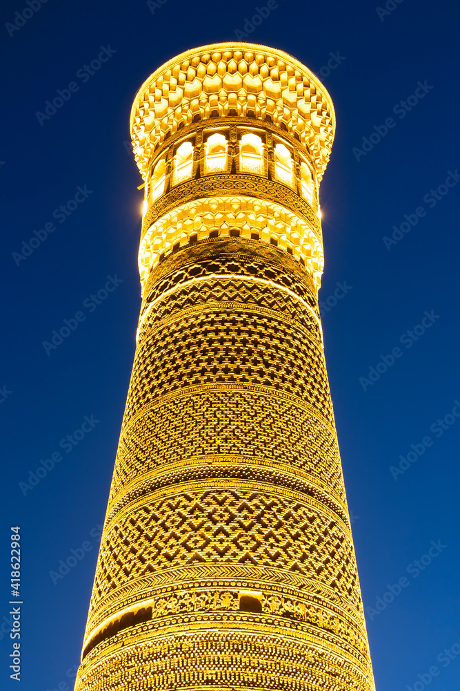Vertical photo of Great Minaret of the Kalon illuminated during the ...