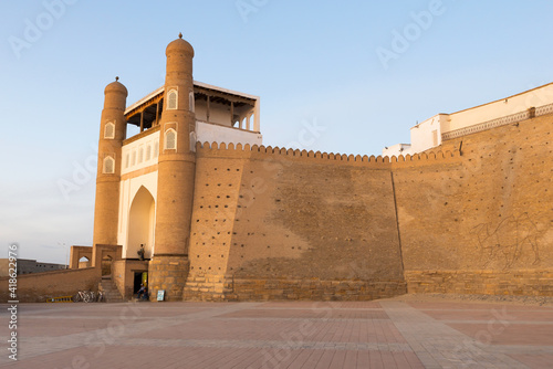 Ancient Wall of the Bukhara Fortress (Ark) in Bukhara, Uzbekistan. The massive fortress is called Ark of Bukhara. Fortified brick wall.