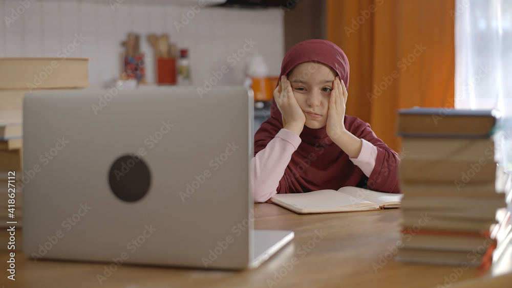 Little girl in a turban tired of being at home and learning from ...