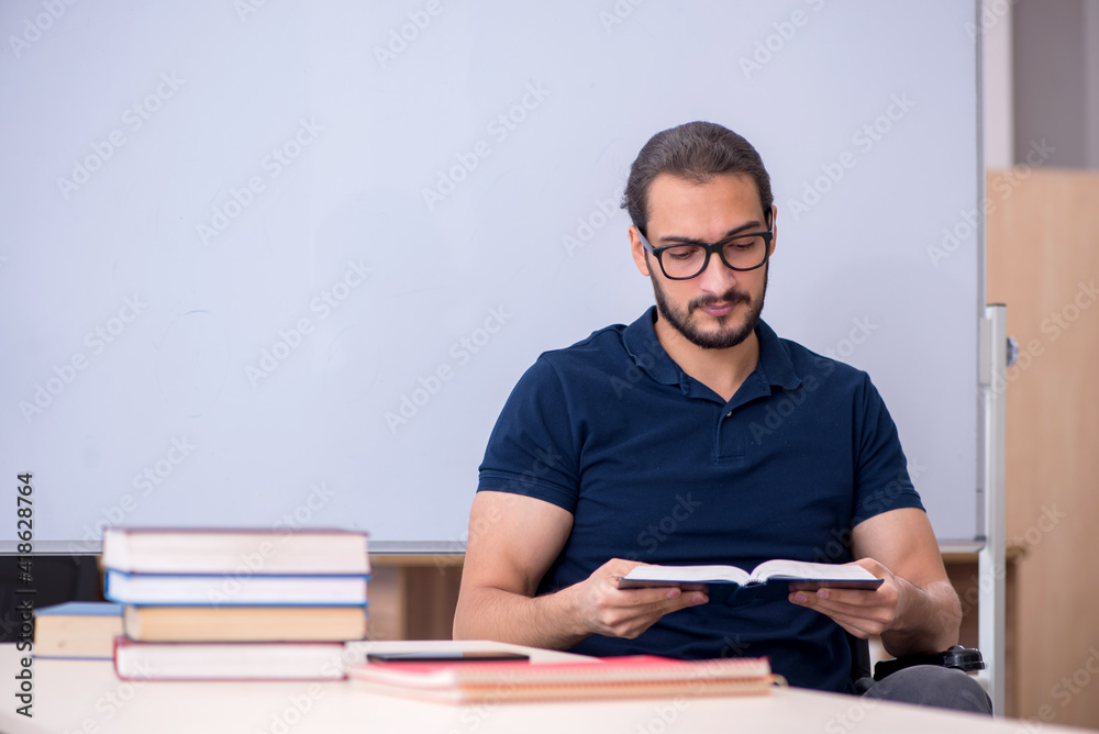 Young male handicapped student in the classroom Young male handicapped student in the classroom
