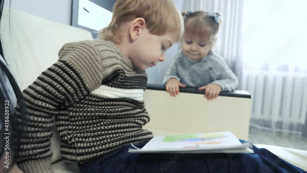 little boy and girl and mom draw teamwork happy family concept. children kids son with are engaged in pencil lifestyle drawing. lesson with children development of creativity little boy and girl and mom draw teamwork happy family concept. children kids son with are engaged in pencil lifestyle drawing. lesson with children development of creativity