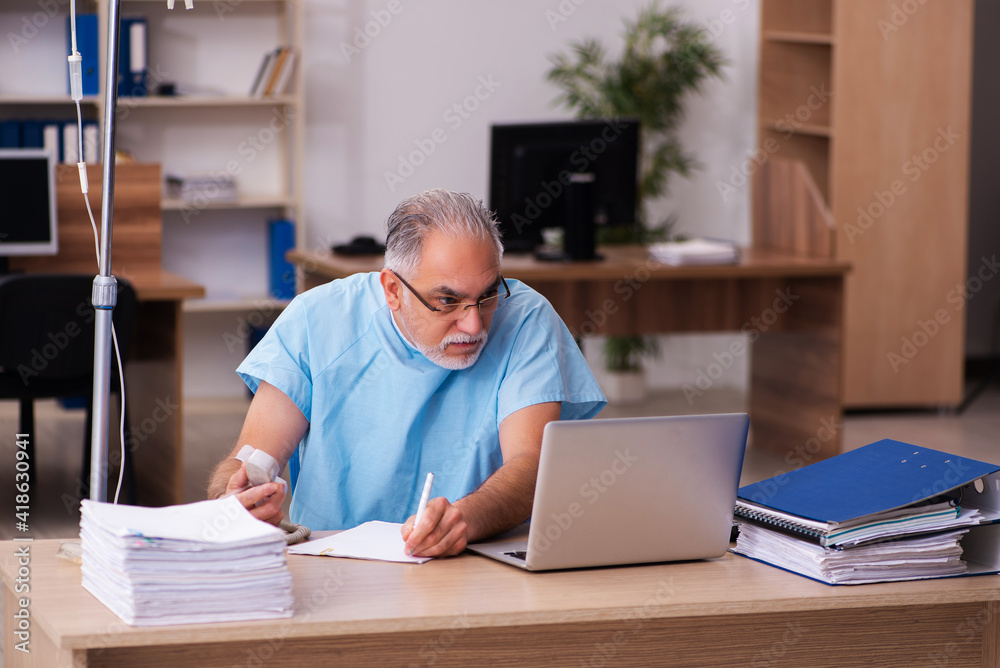 Old male employee in blood transfusion concept Old male employee in blood transfusion concept