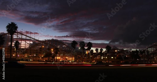 Time-lapse of a sunset over a rollercoaster/amusement park